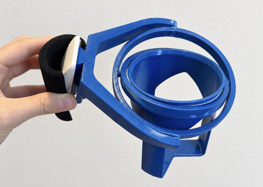 The blue ParkiCup tilted by its foam handle, with the two rings rotated at different angles.